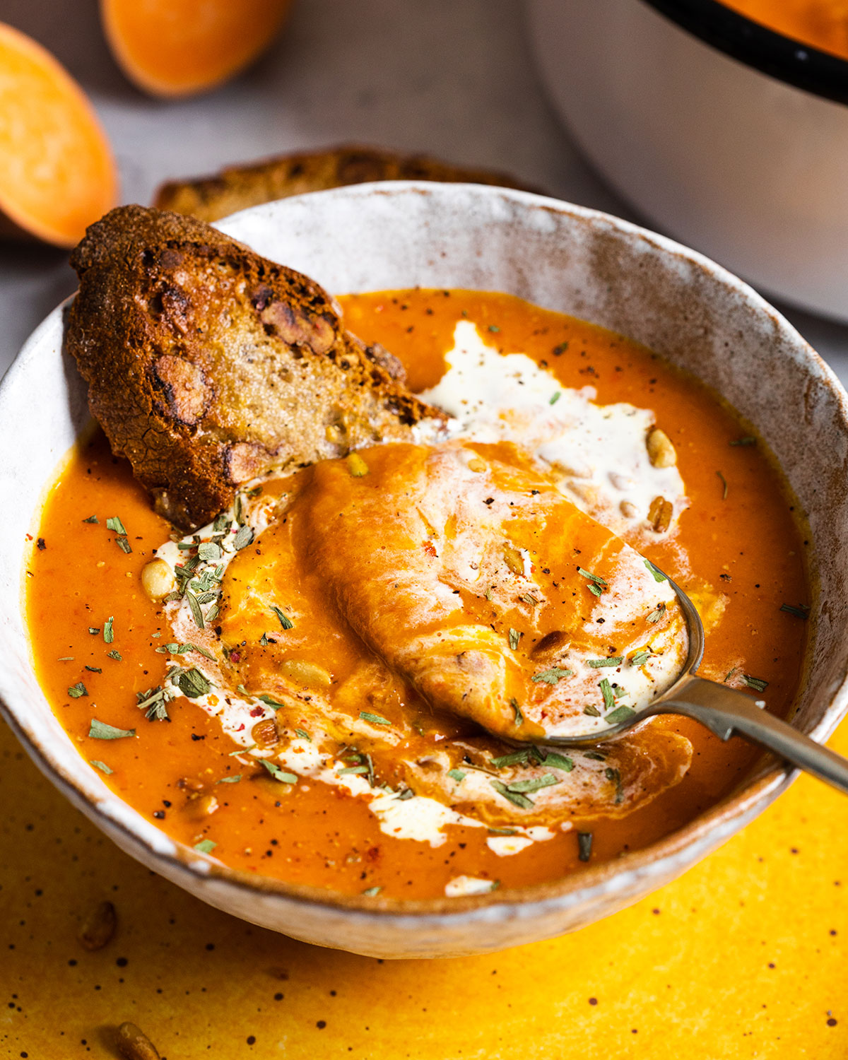 a bowl filled with roasted red pepper soup