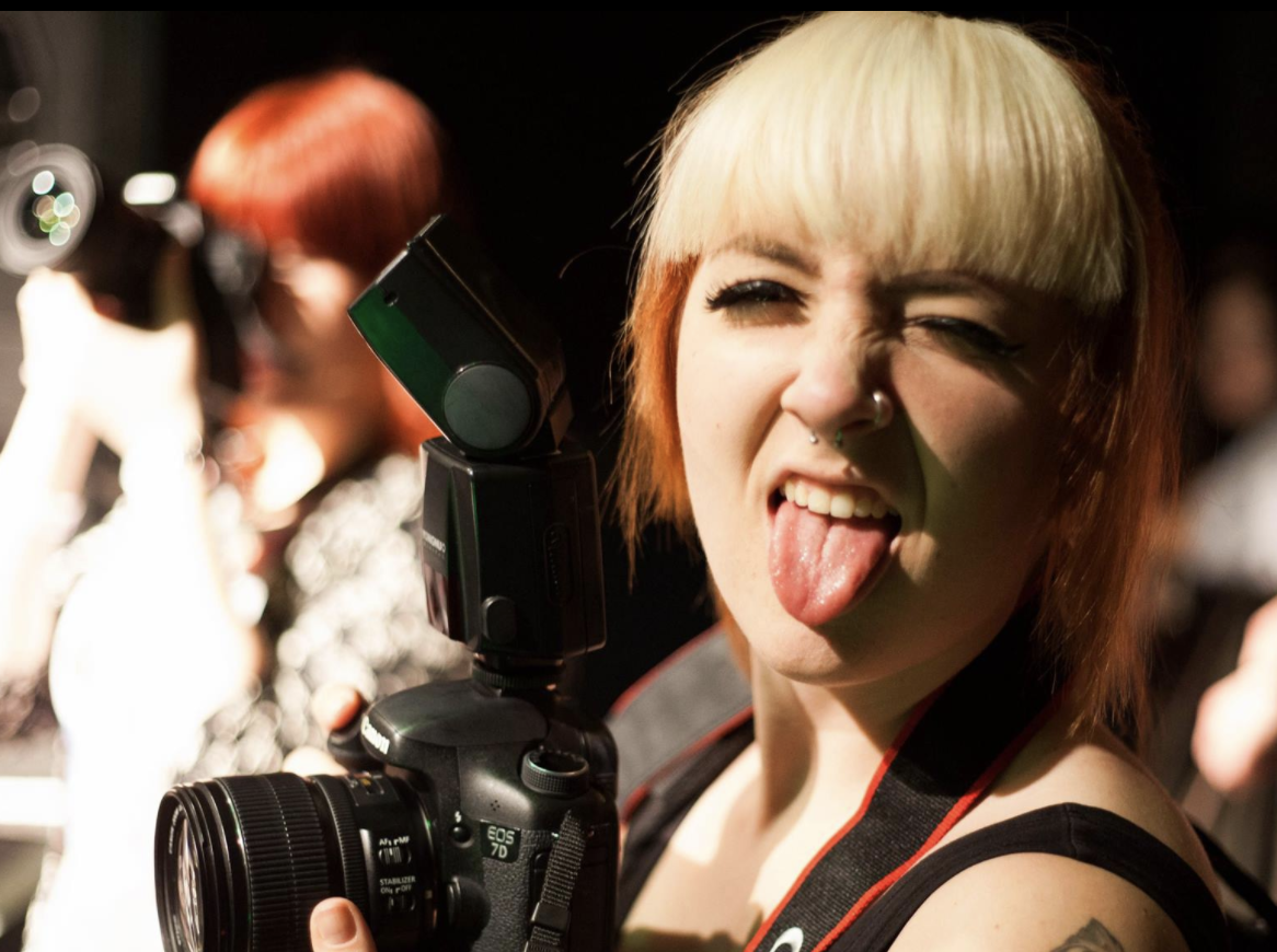 Romy London working as a concert photographer