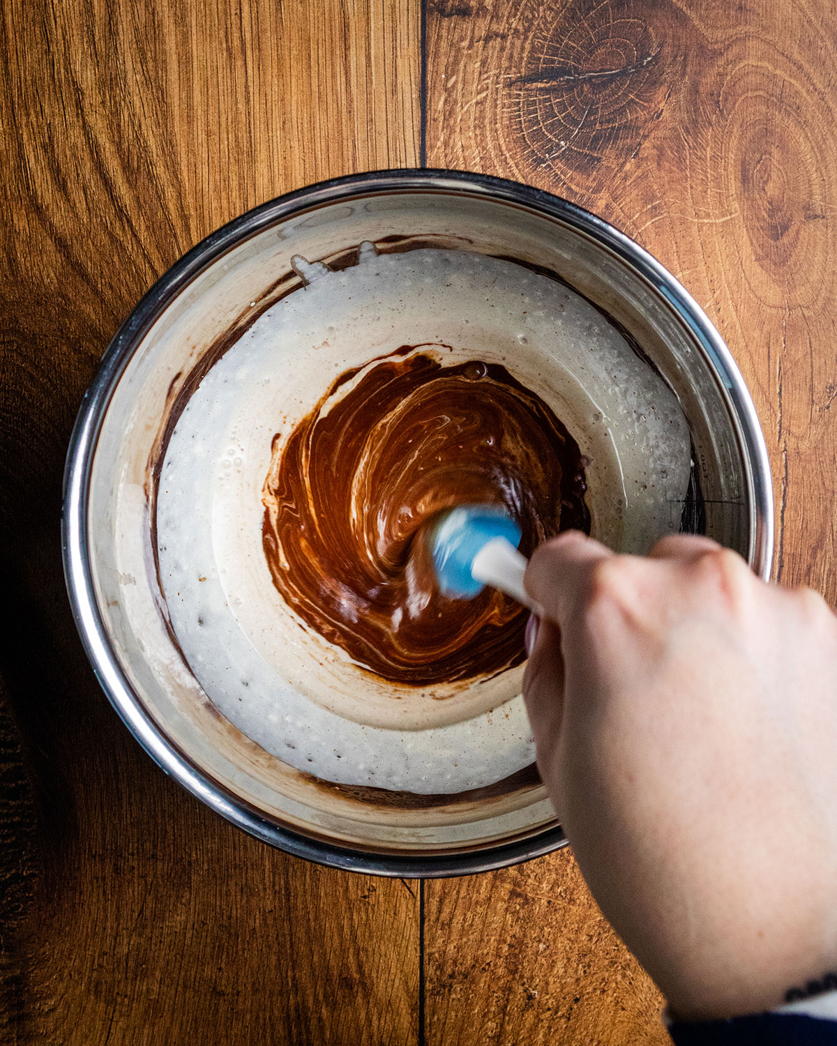 A spatula stirring the vegan chocolate and cream