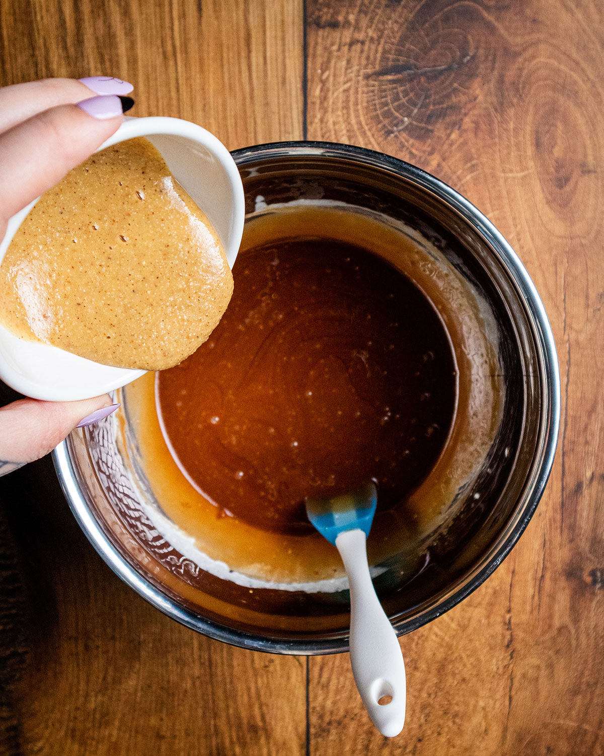 hazelnut butter being added to the bowl