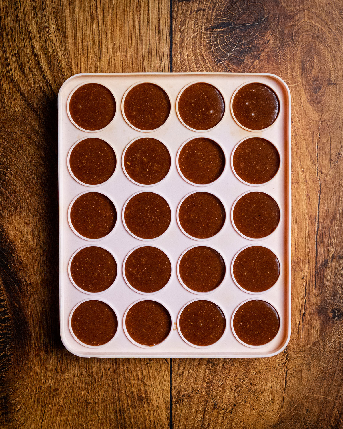 All holes of the silicon tray filled with vegan chocolate and hazelnut cream