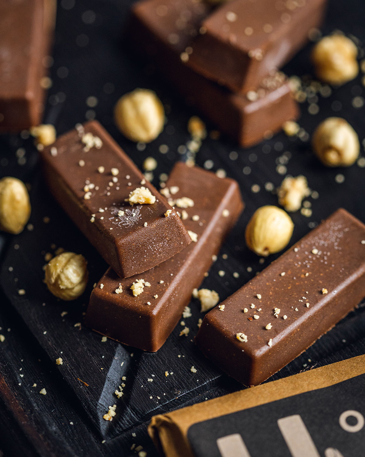 chocolate fudge bars laying on a black serving board