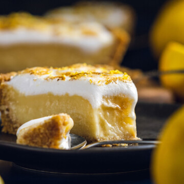 a slice of lemon meringue pie with a bite taken out of it