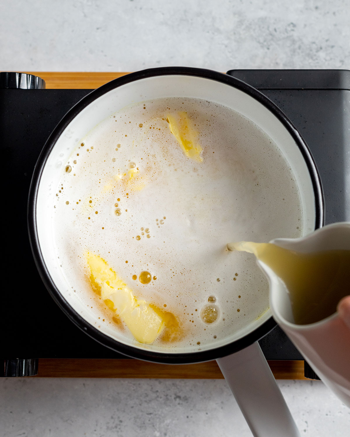 fresh lemon juice added to a saucepan to make vegan lemon curd