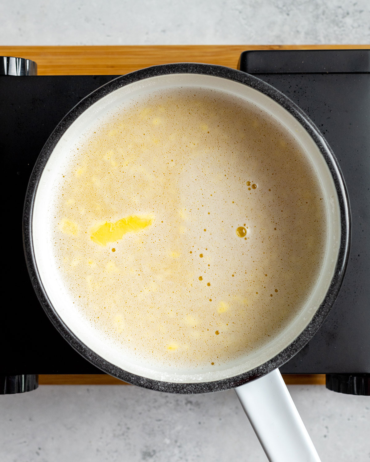 lemon curd filling cooking in a saucepan