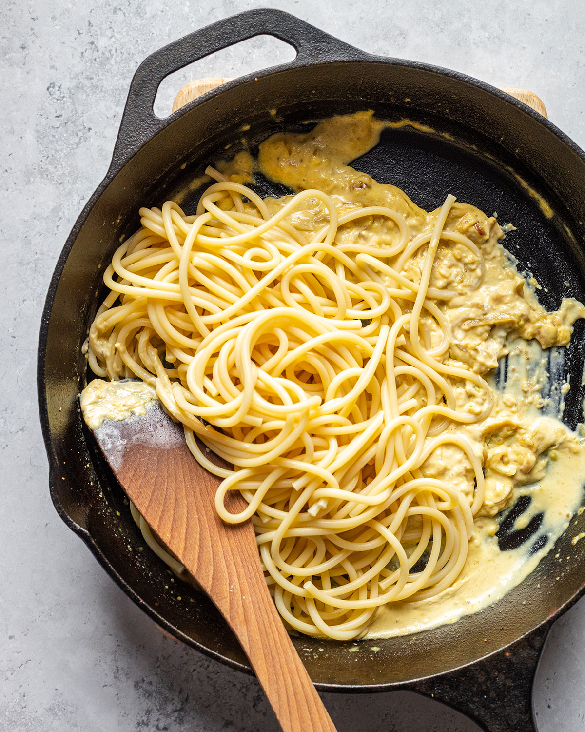 cooked pasta added to the sauce in the skillet