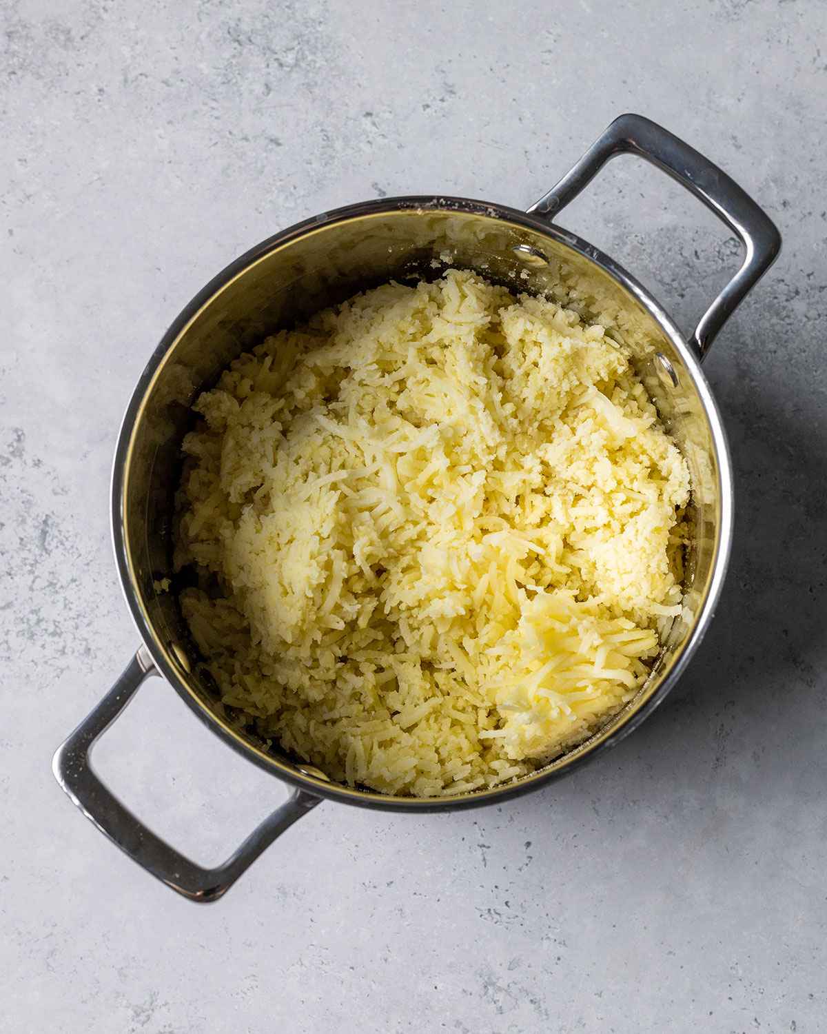 shredded potato in a saucepan