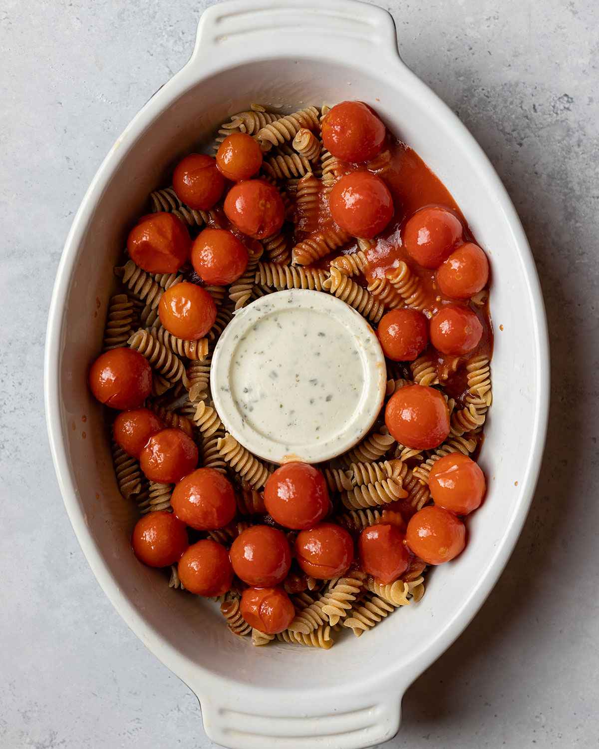 pasta, boursin cheese and tinned cherry tomatoes in the baking dish