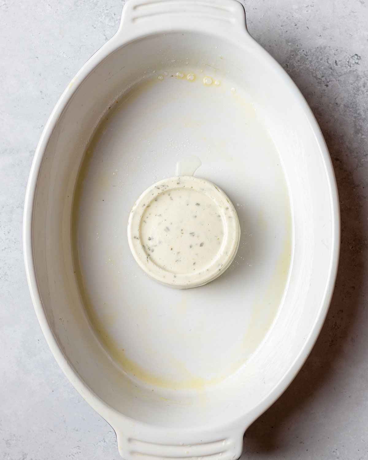 boursin cheese added to the centre of a baking dish