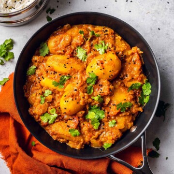 Potato curry in a pan on marble table