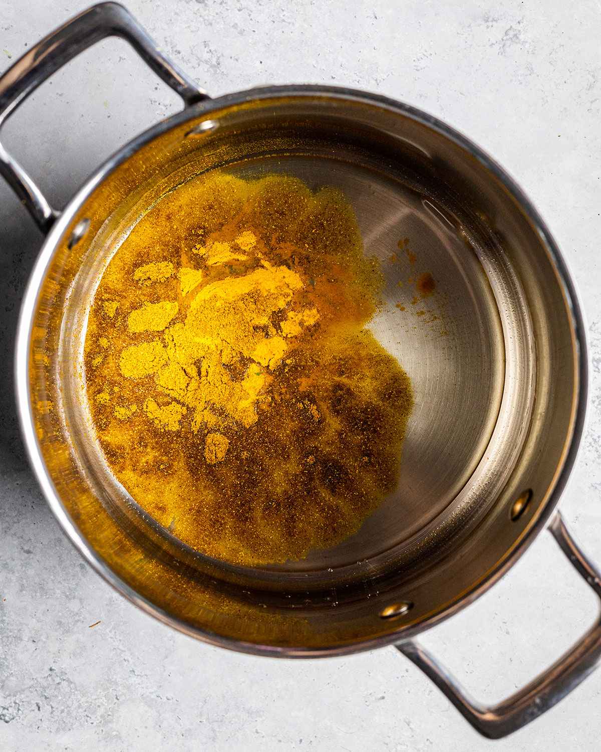 turmeric and garam masala and rapeseed oil in an Olav saucepan