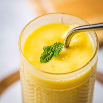 close up of a mango smoothie in a glass