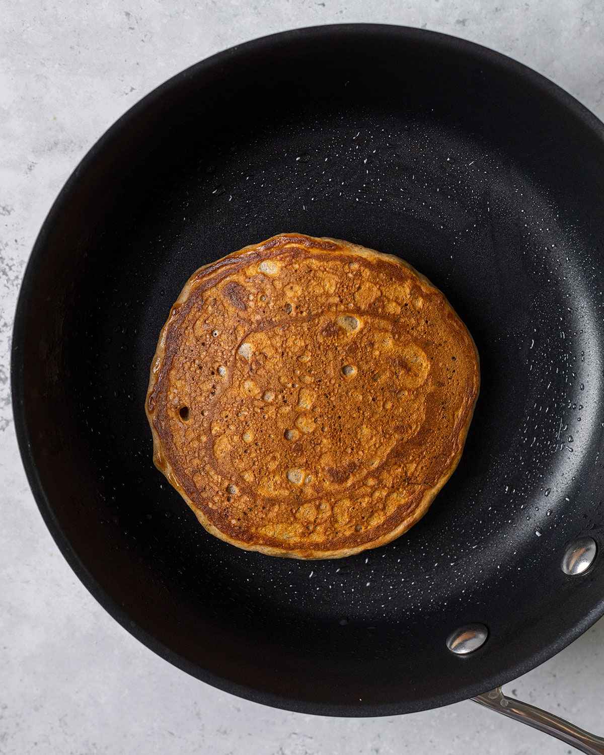 cooked vegan banana pancake in a skillet