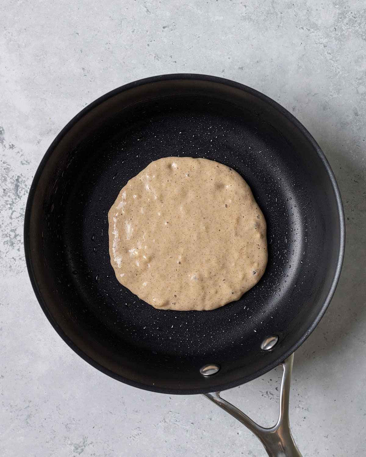 vegan banana pancake batter in a skillet