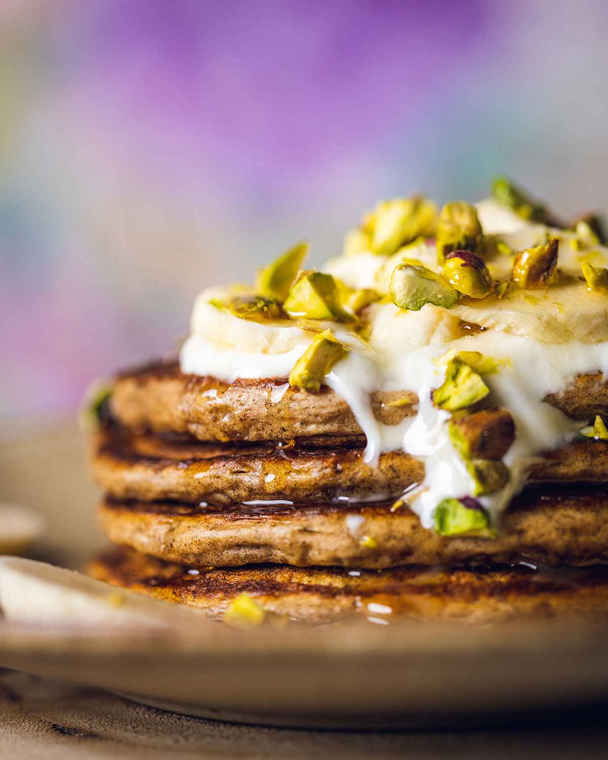 stacked vegan banana pancakes with toppings