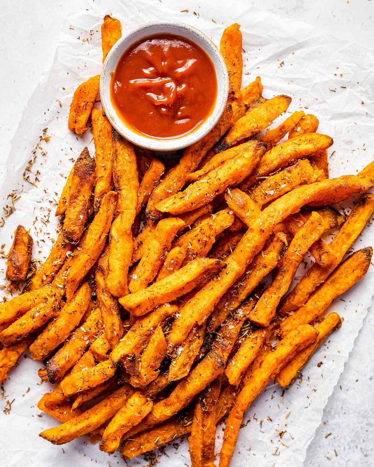 sweet potato fries with ketchup on a white table top 