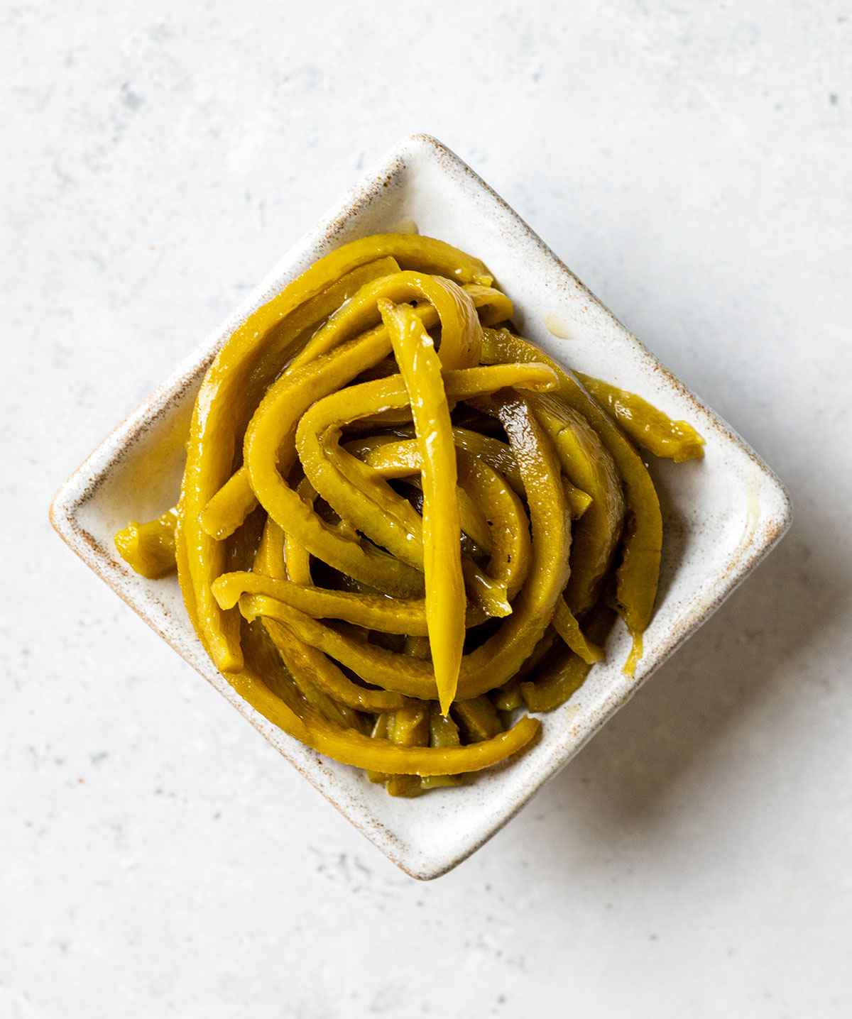 thin poblano pepper strips in a little square bowl