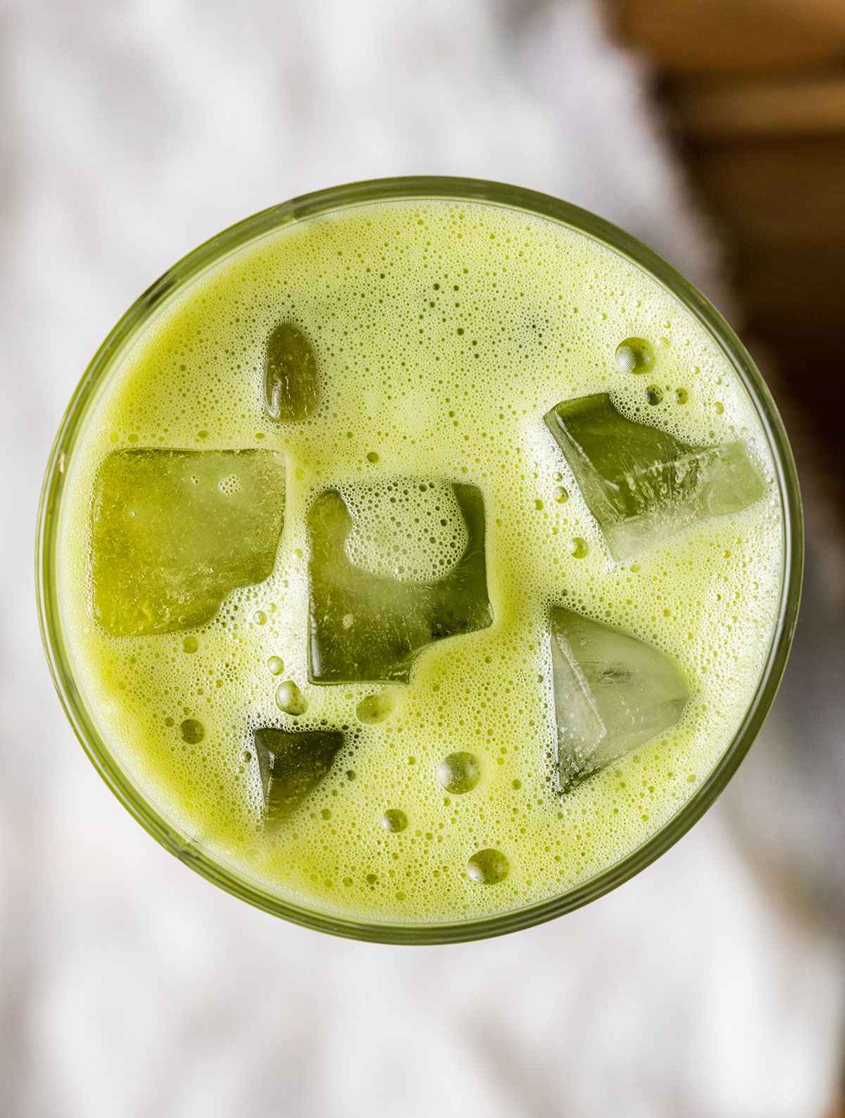 iced matcha photographed from above with ice cubes in a glass