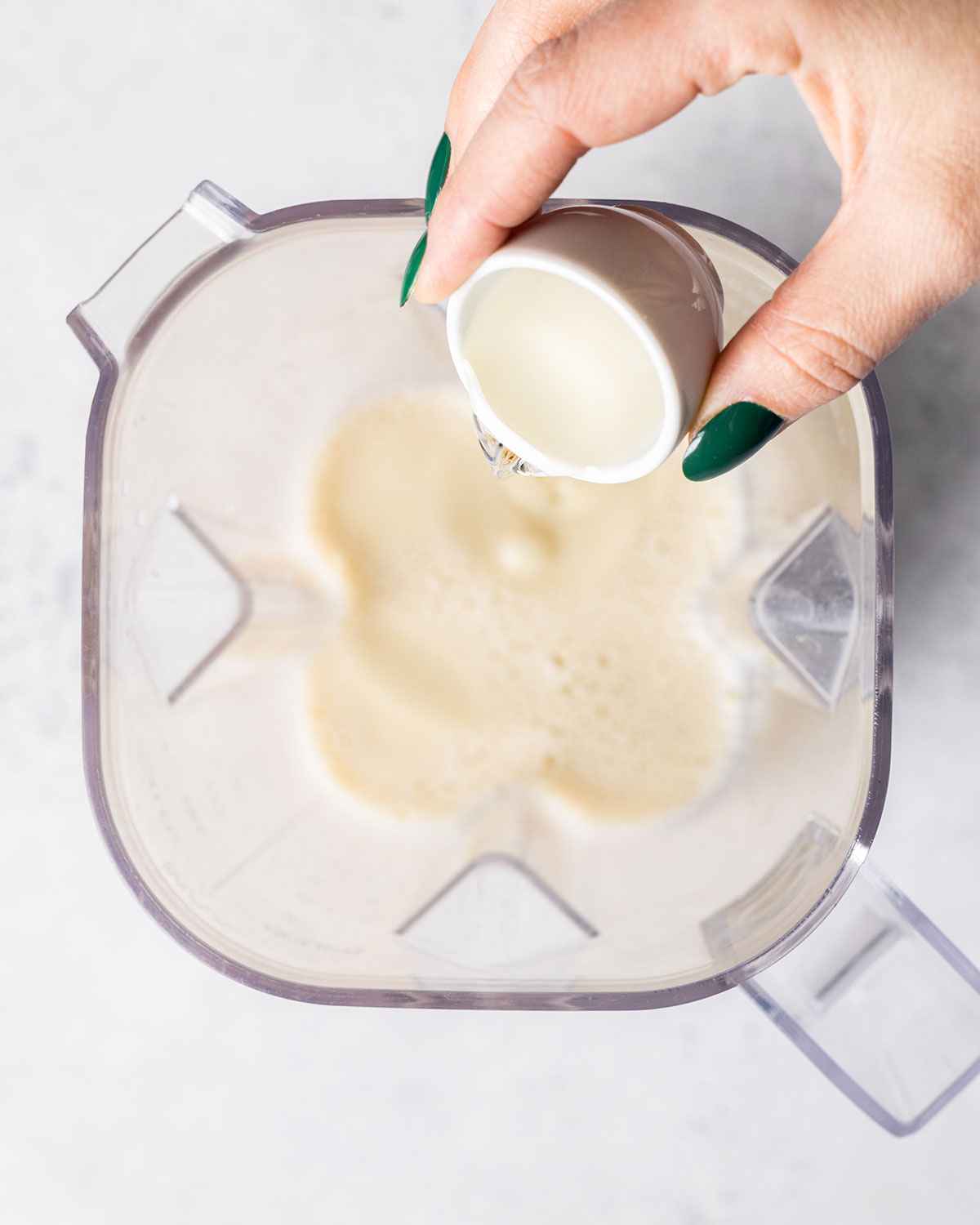 vanilla syrup being added to a blender