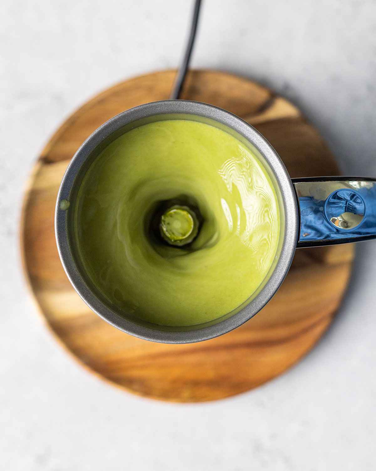 milk frother blending a matcha latte