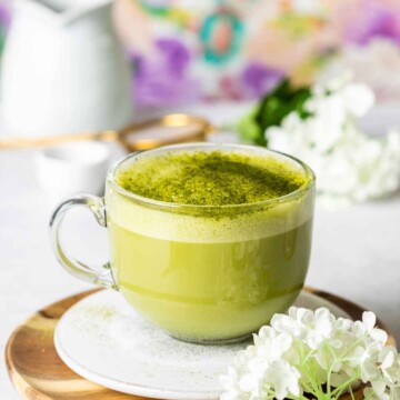 a glass mug filled with hot matcha latte