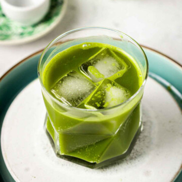a glass filled with ice cubes and Starbucks-style matcha lemonade