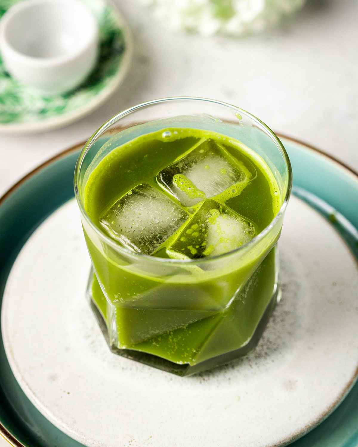 iced lemonade with matcha in a glass with ice cubes