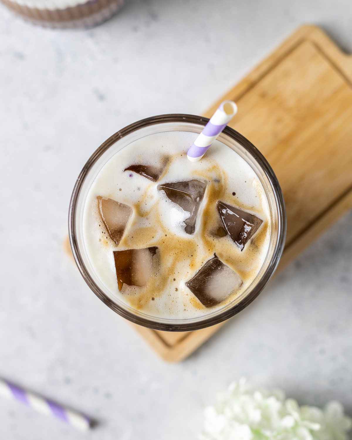 close up of the ice cubes on top of a purple yam latte