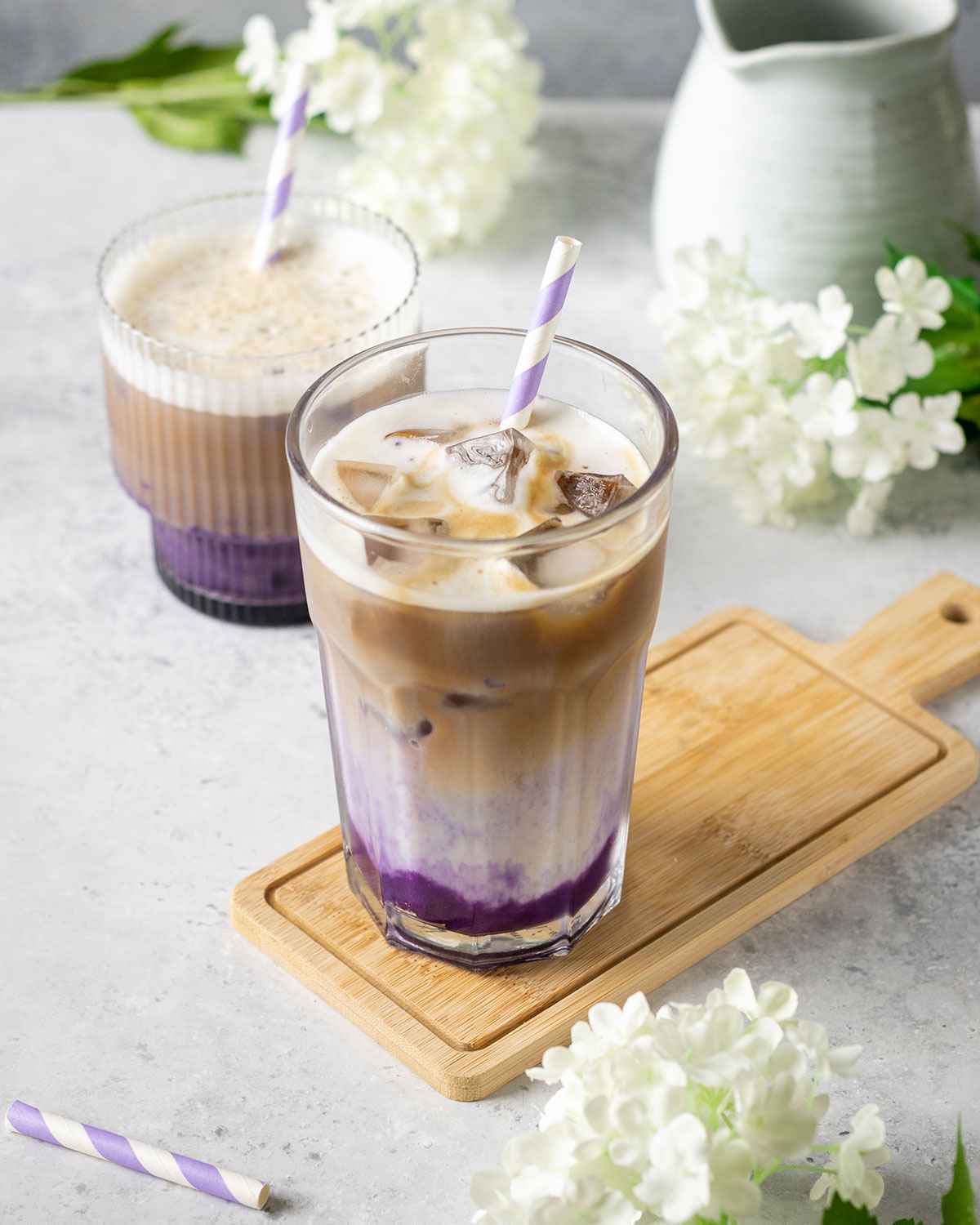 a tall glass with iced ube latte