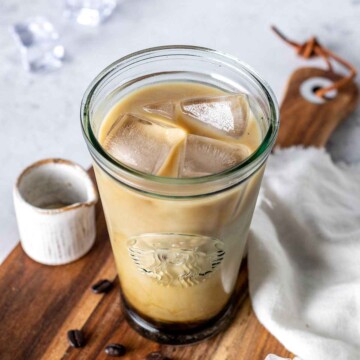 a 16oz glass filled with iced vanilla latte