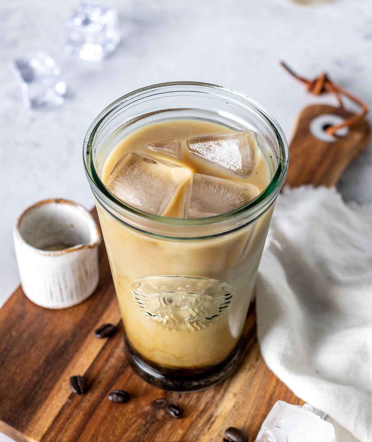 a 16oz glass filled with iced vanilla latte