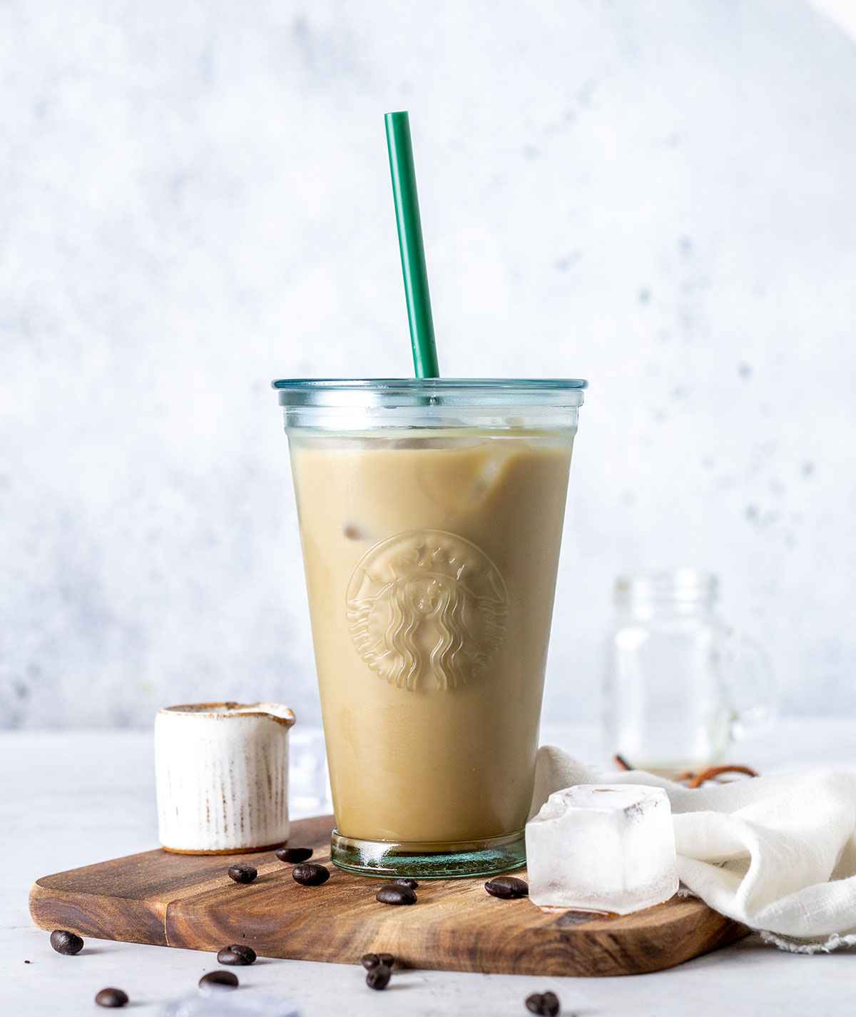 iced vanilla latte in a tall Starbucks glass with a straw