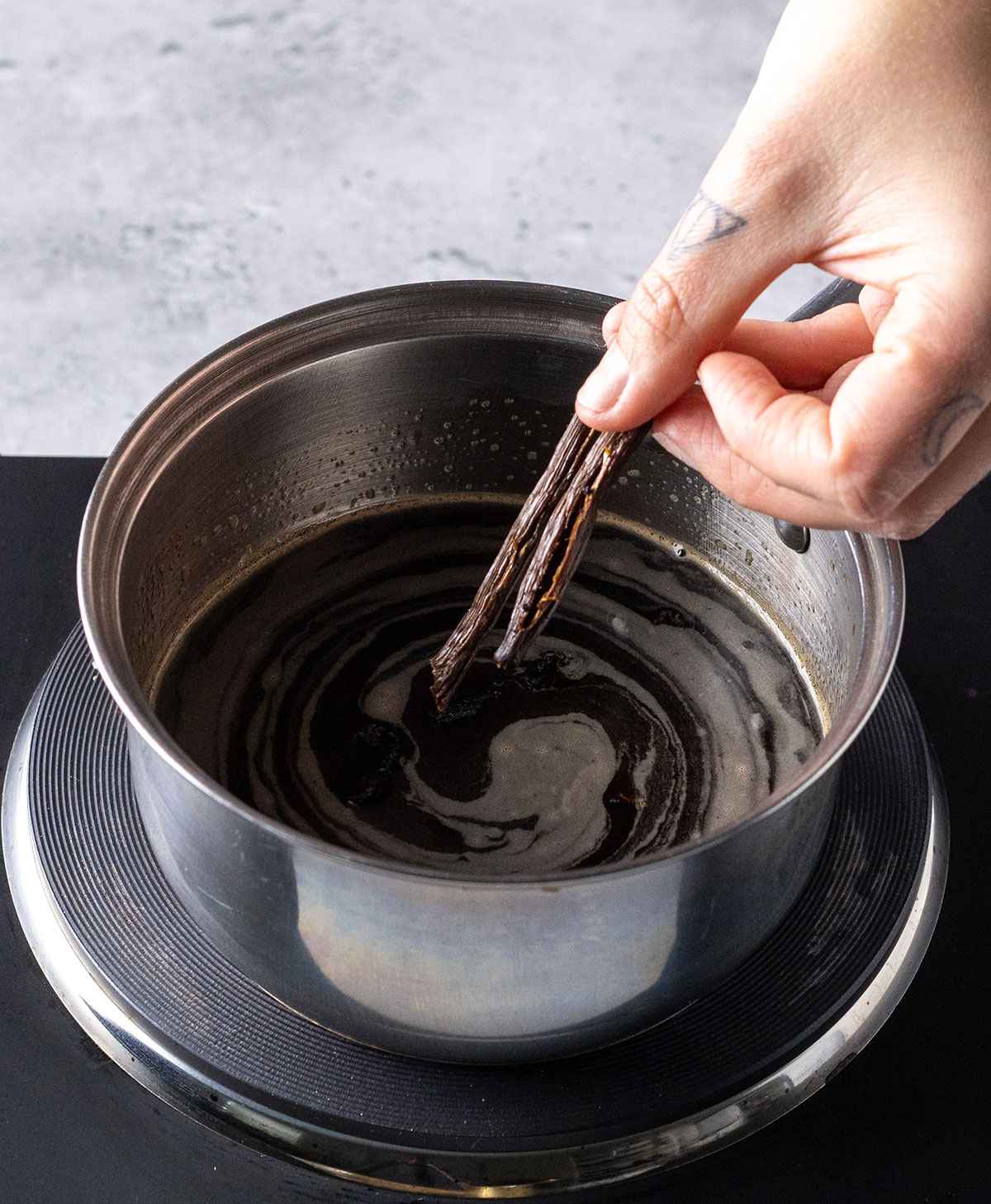 adding vanilla bean to a saucepan