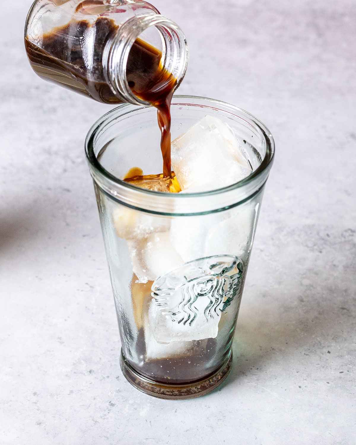 pouring espresso into a tall glass