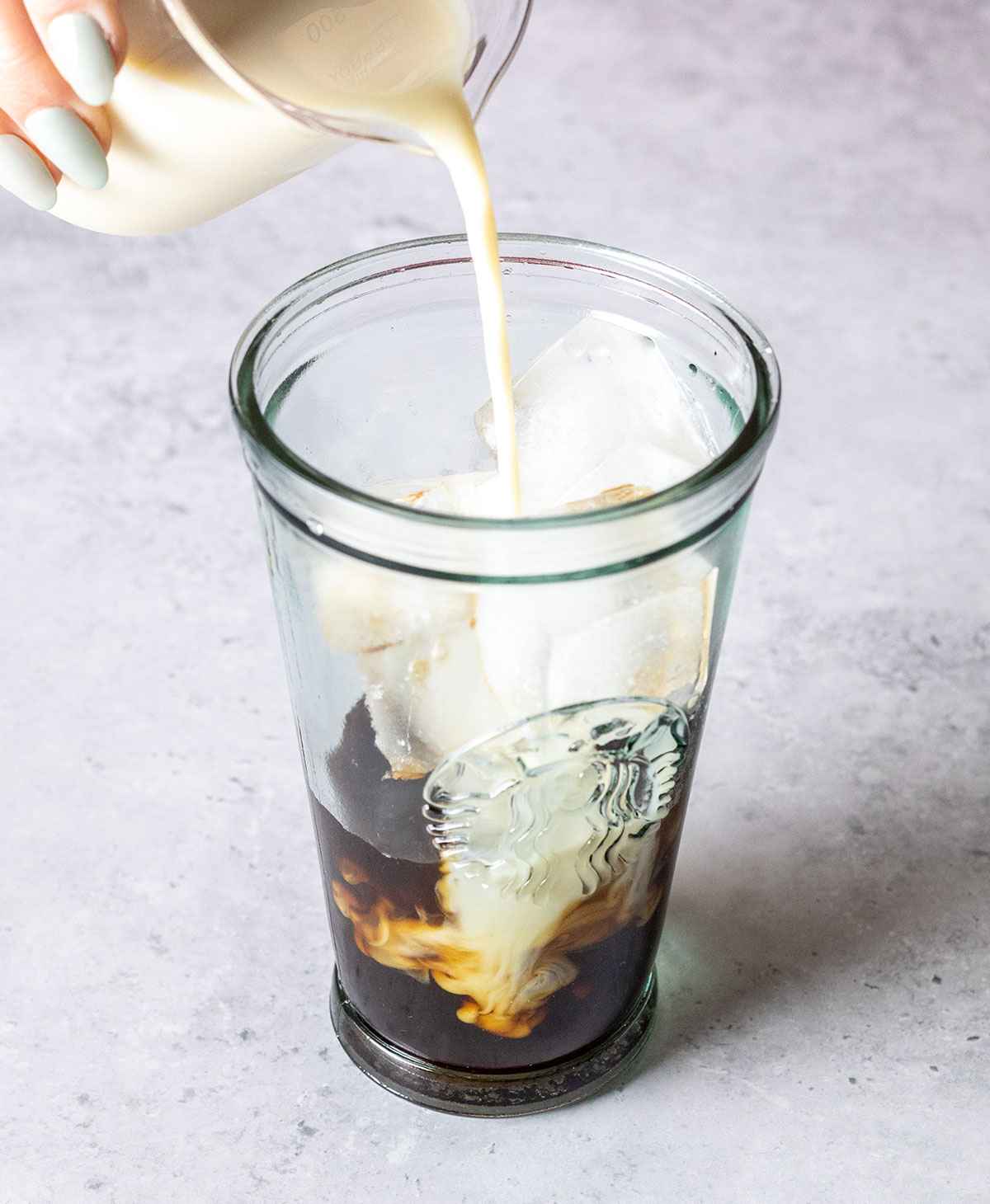 pouring milk into vanilla coffee 1