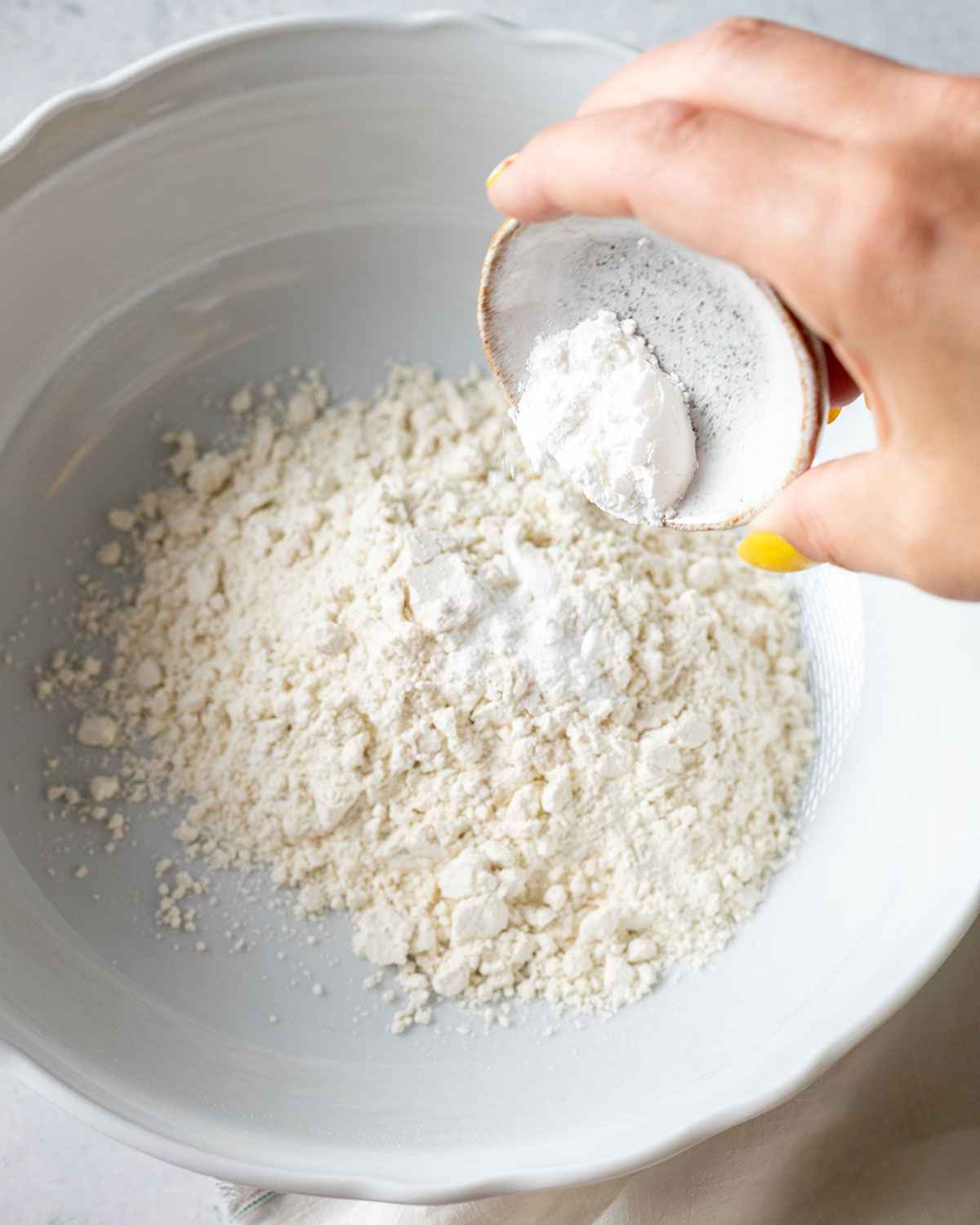 flour and baking powder in a white mixing bowl
