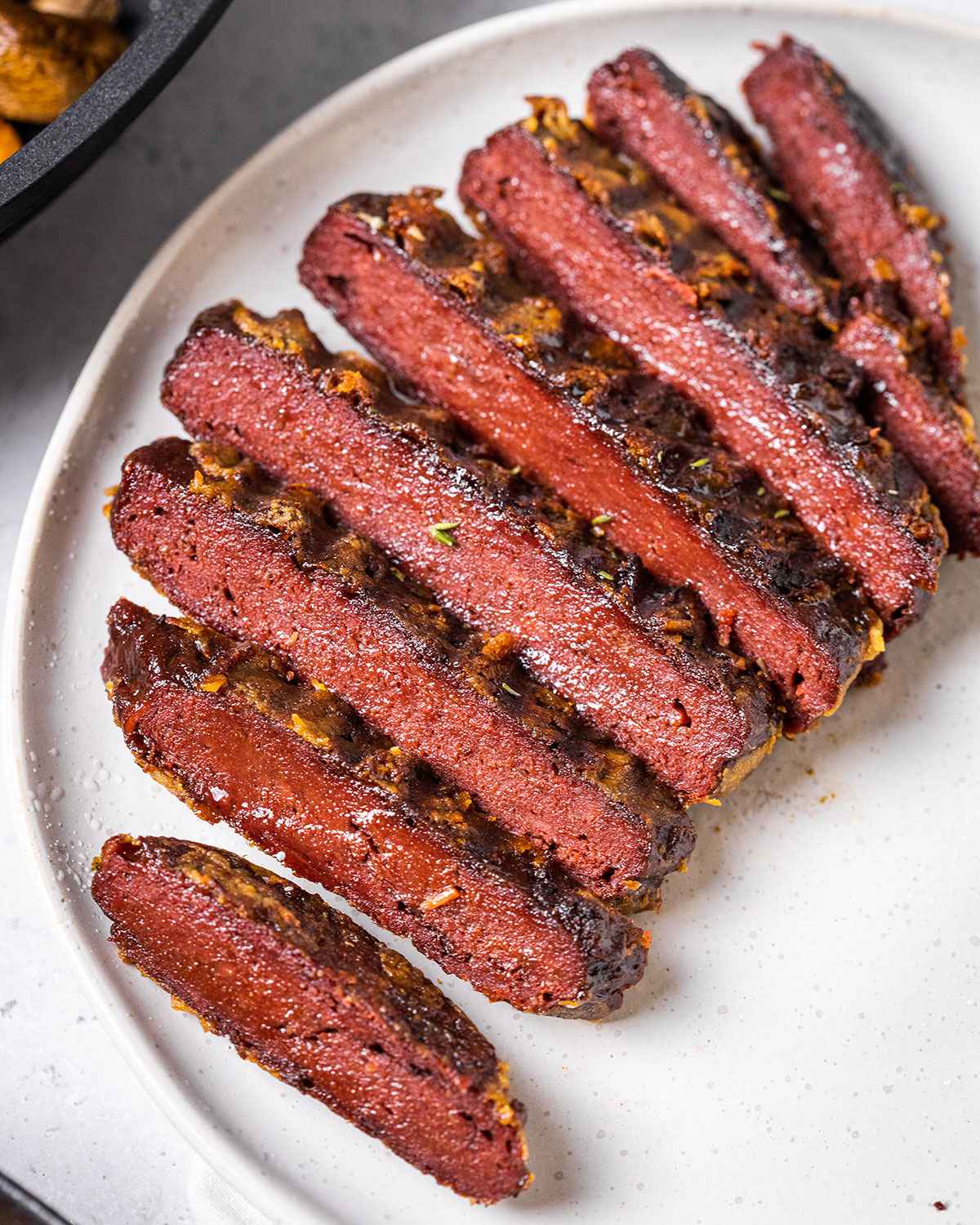 sliced vegan steak on a white plate