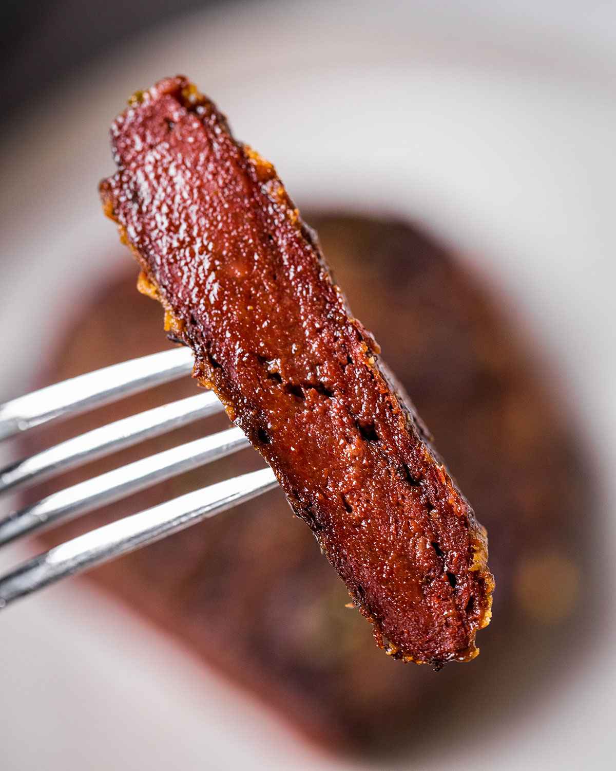 sliced piece of vegan steak showing a red color and juicy chewy texture