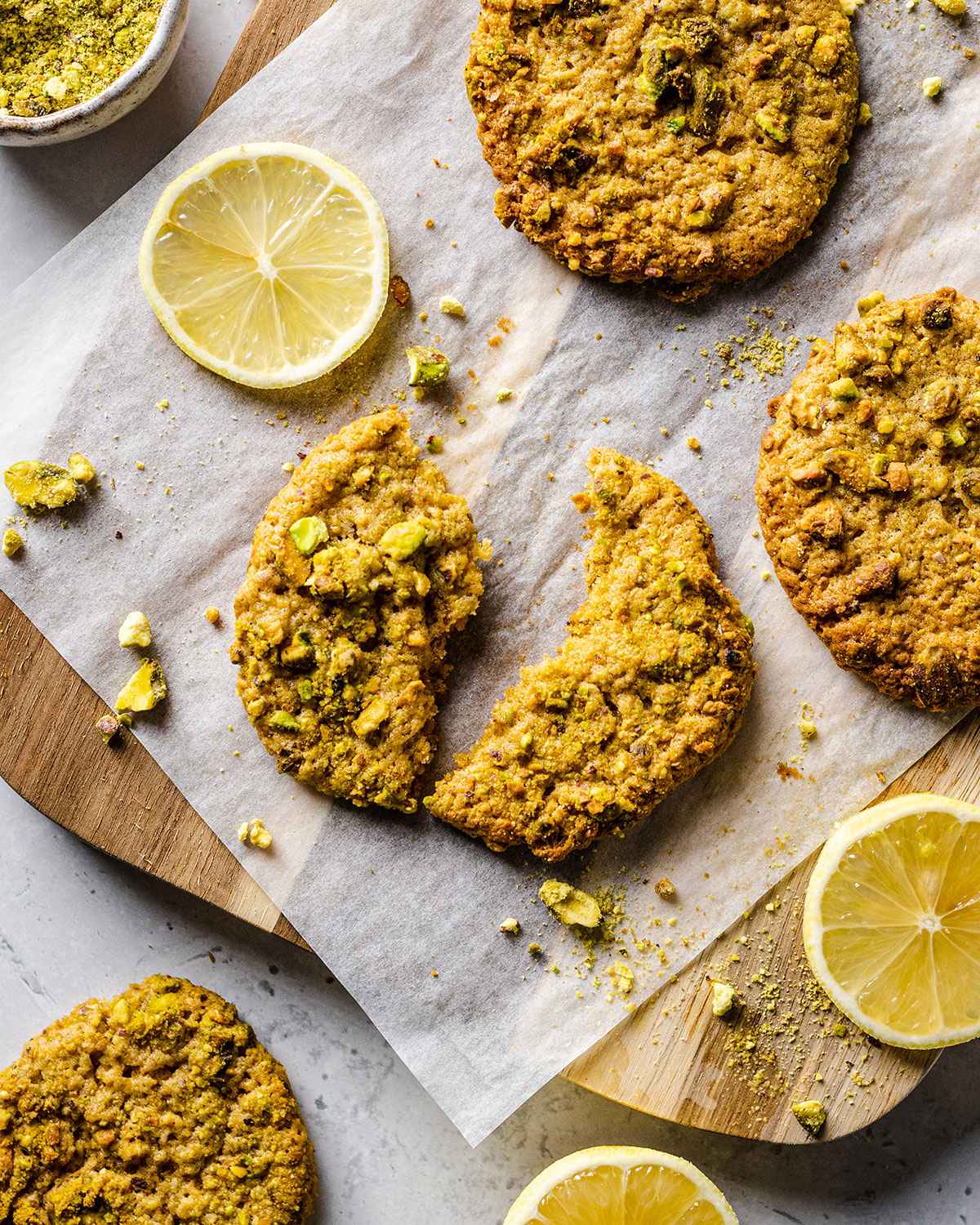 A pistachio cookie broken in half and shown up close.