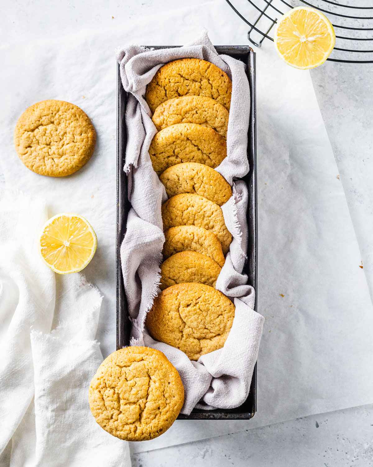 vegan lemon cookies in a cookie jar on a marble table