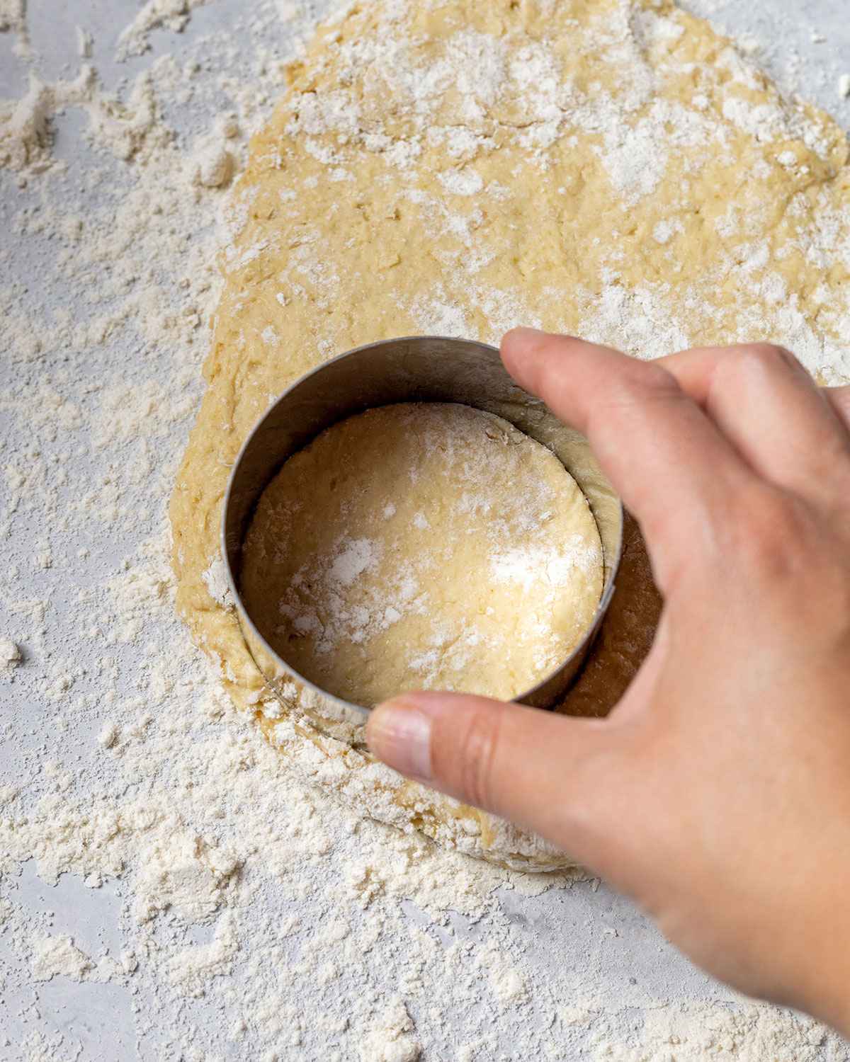 cutting vegan shortcake from rolled out dough with a round pastry cutter