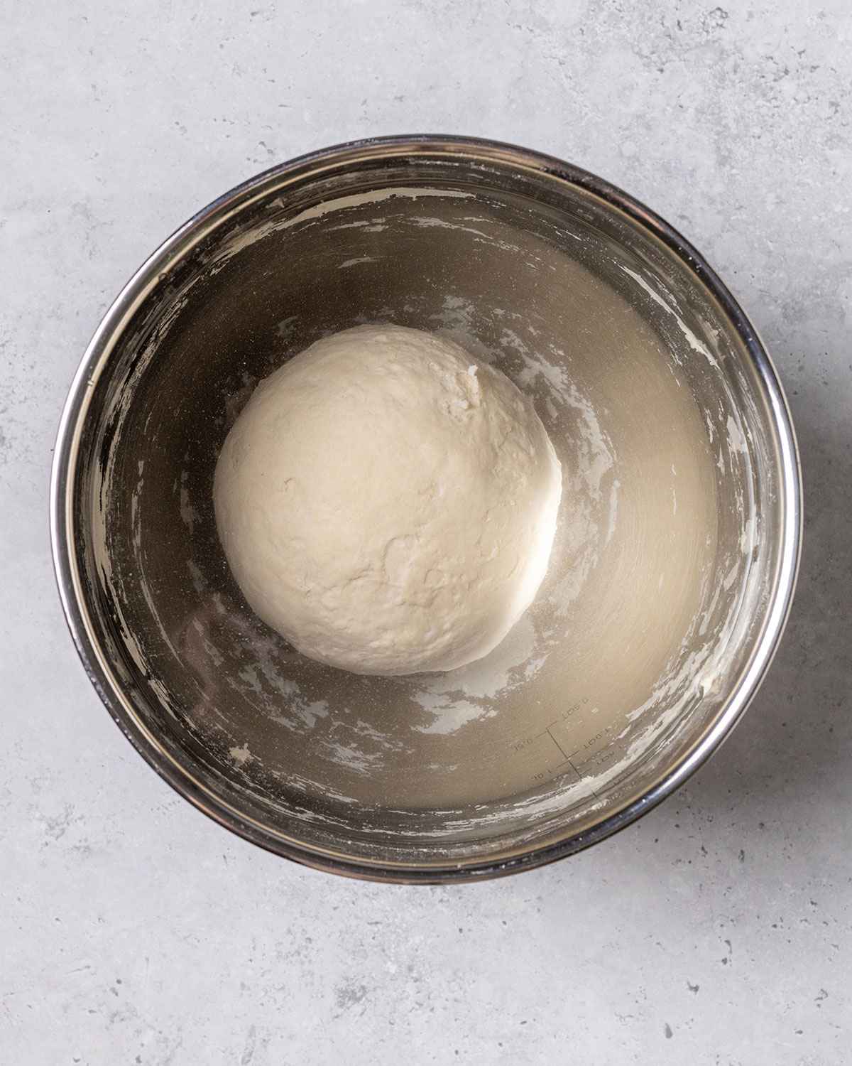 dough ball under water in a bowl