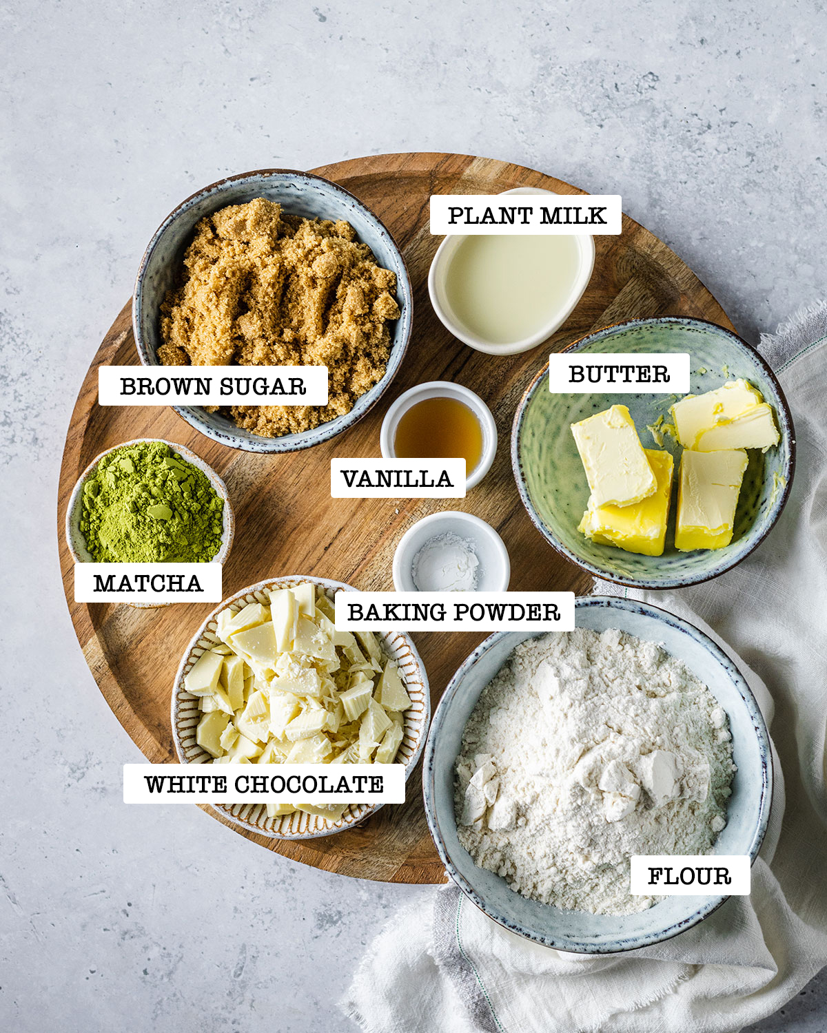 ingredients for matcha cookies on a wooden platter
