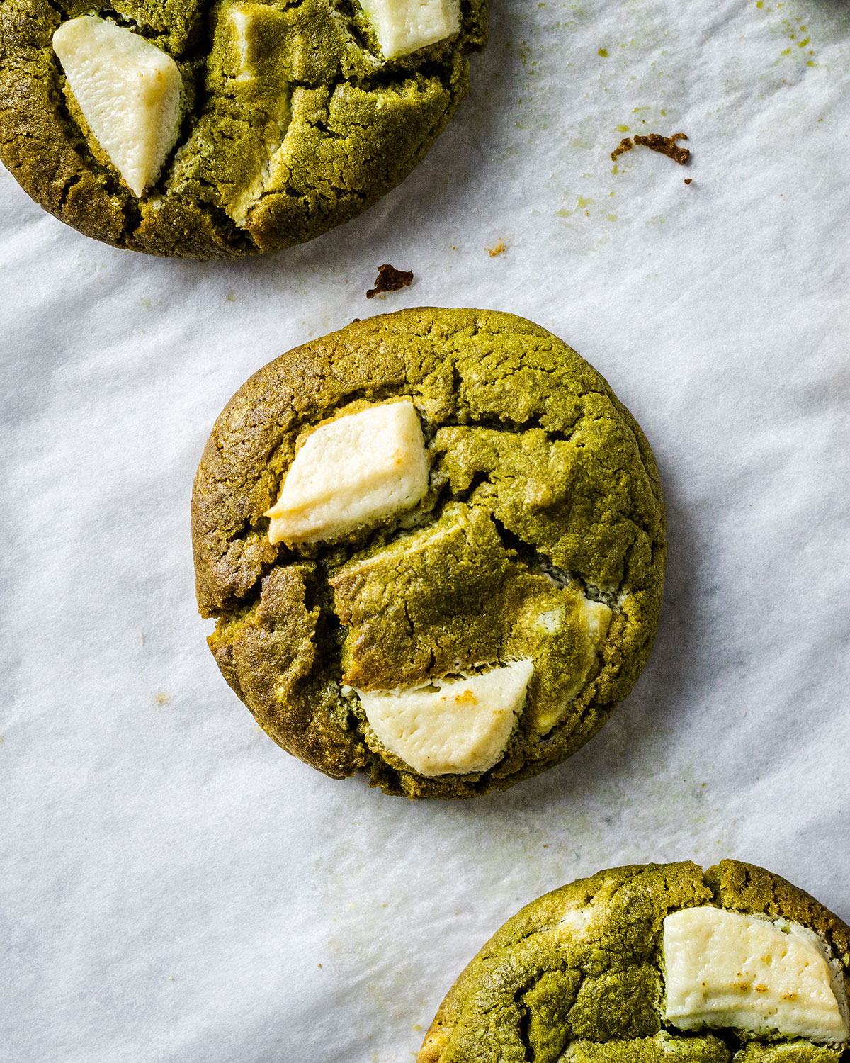 White chocolate matcha cookie on the white baking sheet