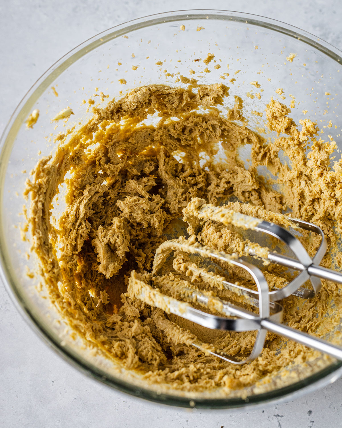 Butter and brown sugar creamed together in a glass bowl