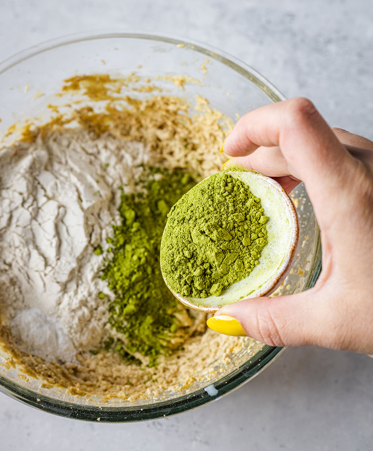 Adding the flour baking powder and Matcha powder into the dry ingredients