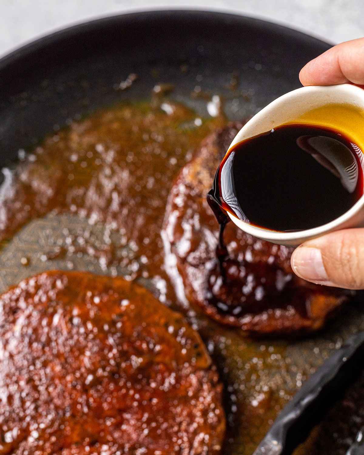 tamari being poured into a skillet