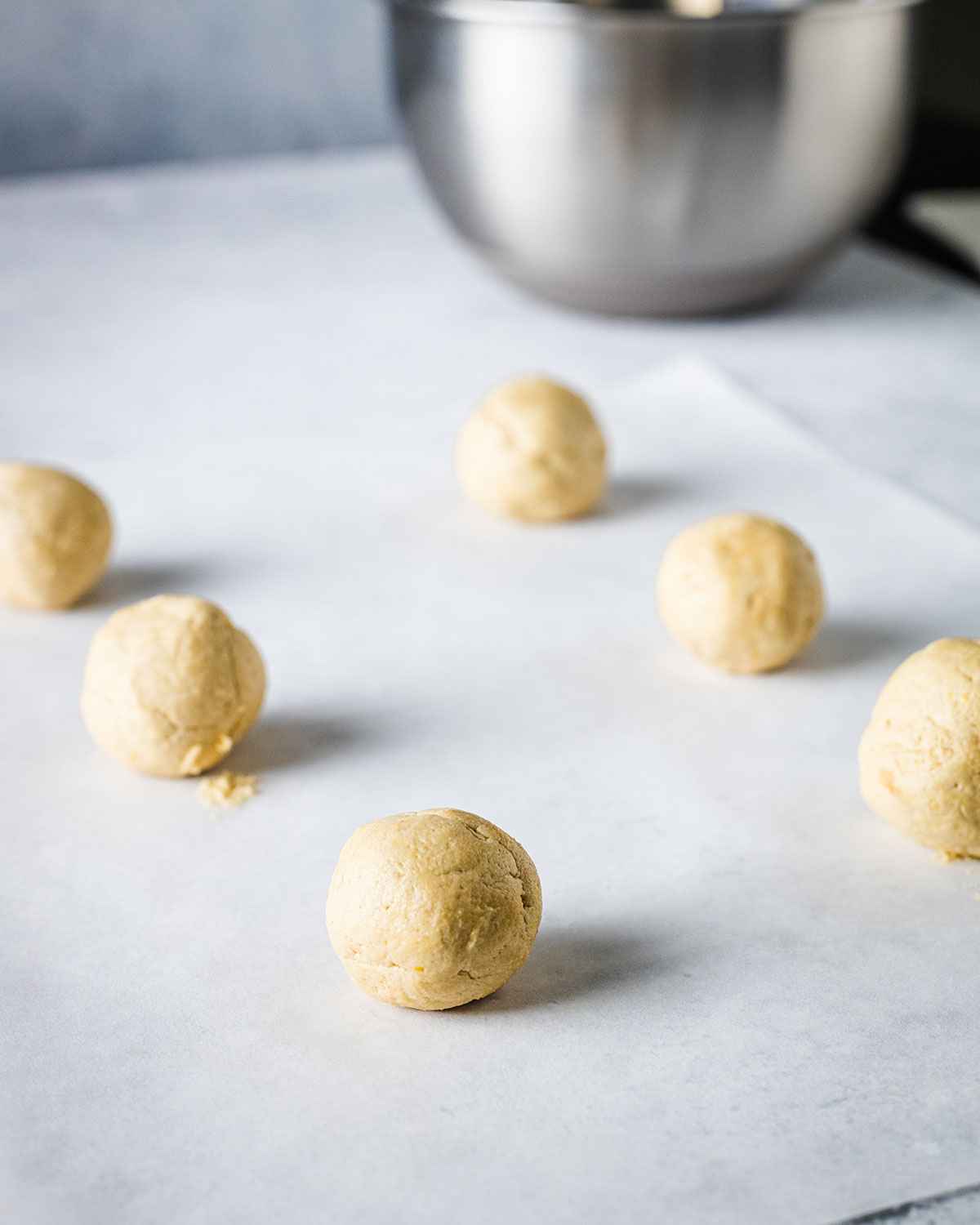 cookie dough balls on a baking sheet