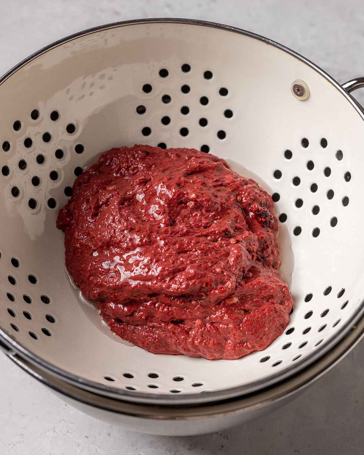 red seitan dough resting in a colander