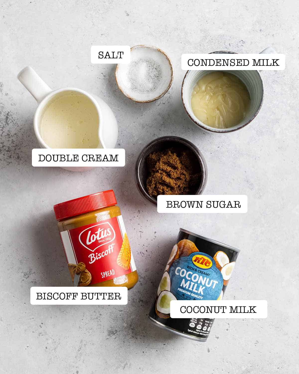 ingredients for biscoff ice cream on a white marble table